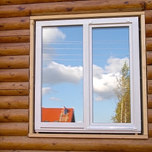 Stock Foto How to put plastic windows in a wooden house